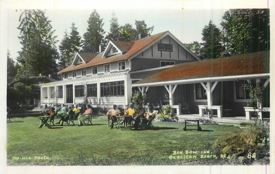 A hand-tinted postcard of the Ben Bow Inn: a long gabled lodge with
                a red roof and a deep covered verandah, guests sitting out on the
                lawn in deckchairs, tall firs behind.